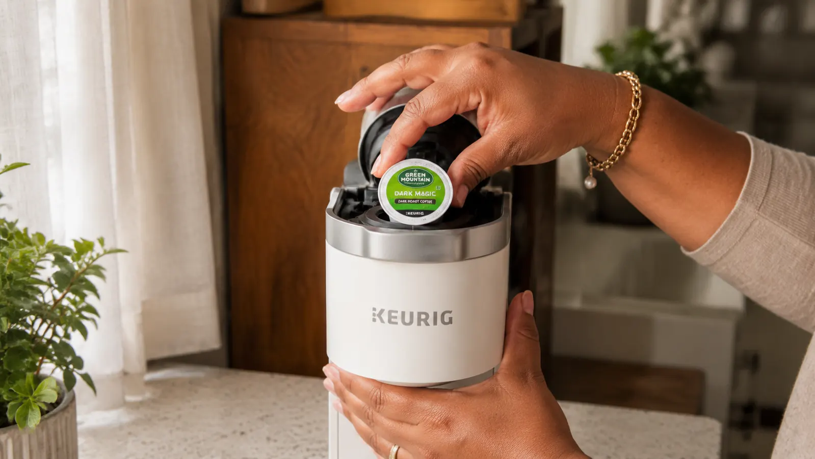 Hand placing a K-Cup pod into a Keurig K-Mini coffee maker